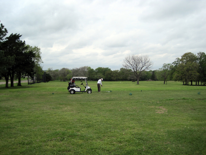 Golfer prepares for round on driving range