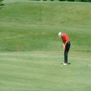 Member putting on the Brenham Country Club golf course