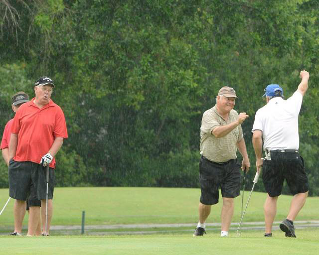 Goflers celebrate after making putt at tournament